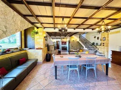 a large living room with a table and chairs at Villa Bellavista in Carini