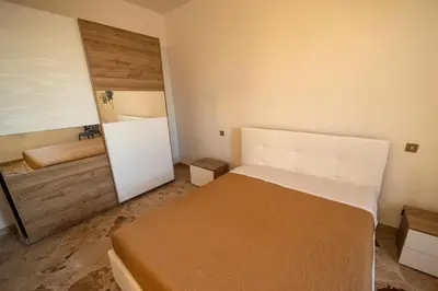 a small bedroom with a bed and a mirror at Baia Marina Oasi in Balestrate