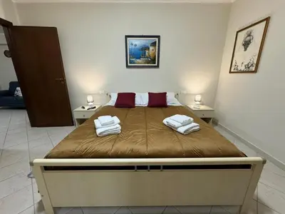 a bedroom with a large bed with towels on it at Maribu in Casteldaccia