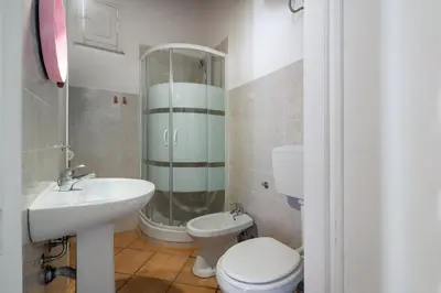 a bathroom with a sink and a toilet and a shower at GuestHost - Casetta del Romito - Lovely Studios in Palermo