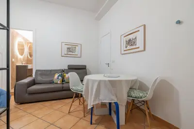 a living room with a table and a couch at GuestHost - Casetta del Romito - Lovely Studios in Palermo