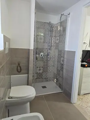 a bathroom with a toilet and a shower at Mak house in Palermo