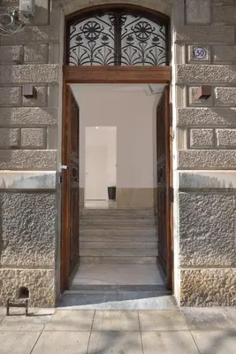 an entrance to a building with a wooden door at Palazzo Gregorietti Boutique Apartments in Palermo