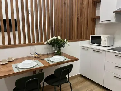 a kitchen with a table with chairs and a microwave at A Casa di Chiara in Palermo