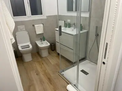 a bathroom with a toilet and a sink and a shower at A Casa di Chiara in Palermo