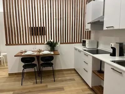 a kitchen with a small table and two chairs at A Casa di Chiara in Palermo