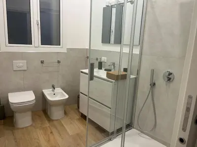 a bathroom with a toilet and a sink and a shower at A Casa di Chiara in Palermo