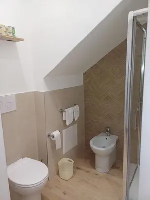 a bathroom with a toilet and a sink at Carruzzata 2 in Bagheria