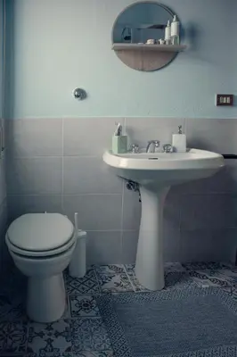 a bathroom with a toilet and a sink at Casa del Gelso Tra Palermo e Cefalù in Trabia