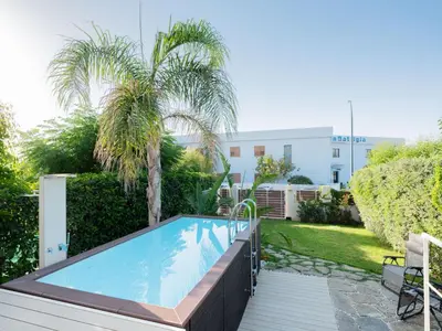 a swimming pool in a yard with trees and a building at CasaSol - Live Your Sol in Alcamo