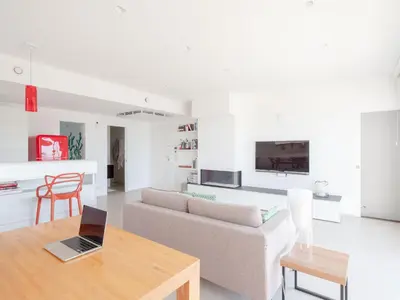 a living room with a couch and a table with a laptop at CasaSol - Live Your Sol in Alcamo