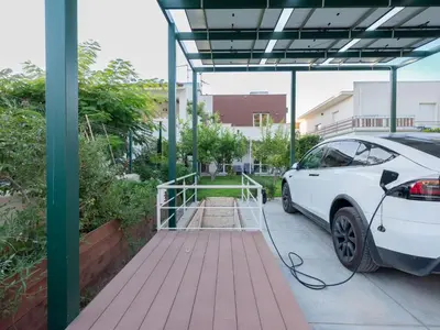 a white car is parked under a garage at CasaSol - Live Your Sol in Alcamo