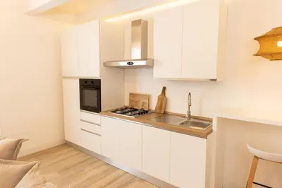 a kitchen with white cabinets and a sink at Dimora Blanca in Bagheria
