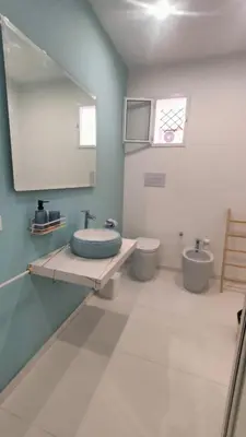 a bathroom with a sink and a toilet at utveggio view apartment in Palermo
