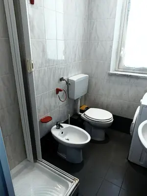 a bathroom with a toilet and a sink at Casa di Laura - Aspra vista mare in Bagheria