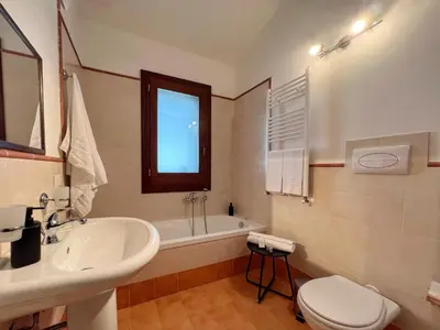 a bathroom with a toilet and a sink at Villa Oxidiana with pool and garden in Campofelice di Roccella