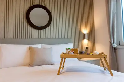 a white bedroom with a bed and a window at Bella Vista nel centro storico in Palermo