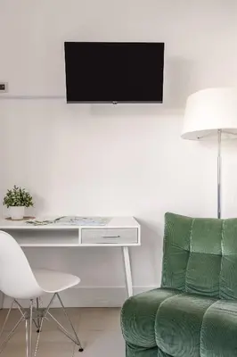 a living room with a desk and a green chair at Bella Vista nel centro storico in Palermo