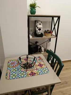 a table with a colorful table cloth on it at Calderai 52 Apartments in Palermo