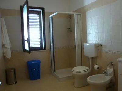 a bathroom with a shower and a toilet and a sink at Appartamenti Campo in Trappeto
