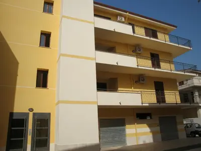 an apartment building with balconies on the side of it at Appartamenti Campo in Trappeto