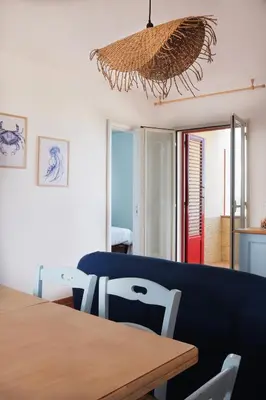 a dining room with a wooden table and chairs at Arancina Abbronzata in Balestrate