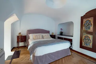 a bedroom with a bed and a wooden floor at La Casena del Principe in Palermo