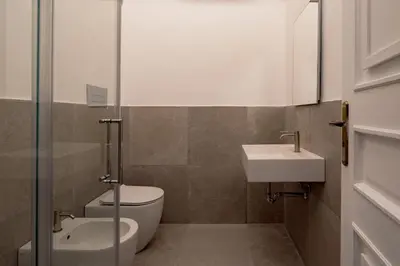 a bathroom with a toilet and a sink at La Casena del Principe in Palermo