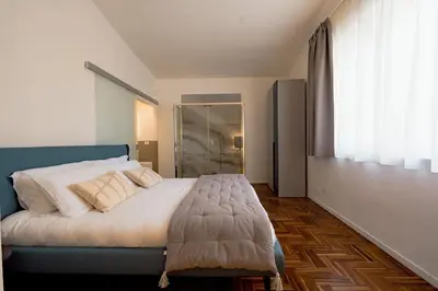 a bedroom with a large bed with white sheets and pillows at La Casena del Principe in Palermo