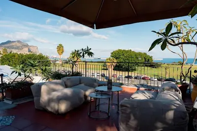 a patio with two couches and a view of the ocean at La Casena del Principe in Palermo