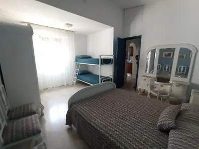 a bedroom with a bed and a mirror at Gioia Guesthouse in Alcamo