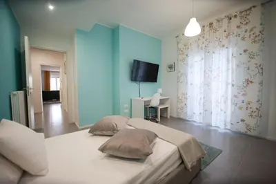 a bedroom with a large bed with two pillows on it at Casa Pisani 274 in Palermo