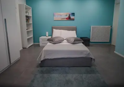 a blue bedroom with a bed with two pillows at Casa Pisani 274 in Palermo