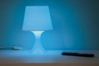 a lamp sitting on a table next to a remote control at Casa Pisani 274 in Palermo