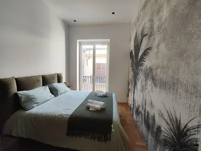 a bedroom with a bed and a large wall at Brunaccini Apartment in Palermo