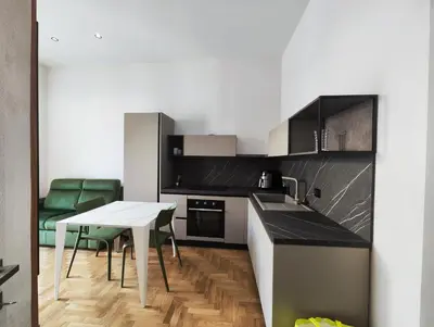a kitchen with a white table and a white table at Brunaccini Apartment in Palermo