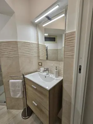 a bathroom with a sink and a mirror at Casa Amato appartamento alla zisa in Palermo