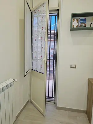 a hallway with a door with a window in it at Casa Amato appartamento alla zisa in Palermo