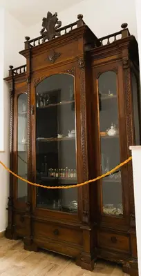 a wooden cabinet with a yellow rope around it at Sweet Home Pioppo in Pioppo