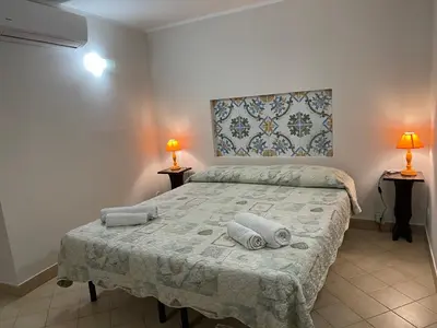 a bedroom with a bed with towels on it at Norman City House in Palermo