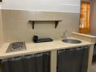 a kitchen counter top with a sink and a counter top at Norman City House in Palermo