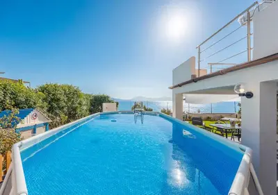 a large blue swimming pool next to a building at Villa dei tramonti in Terrasini