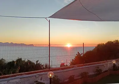 a view of the ocean at sunset from a balcony at Villa dei tramonti in Terrasini