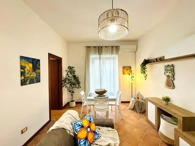 a living room with a couch and a table at Il Moro Suite in Palermo