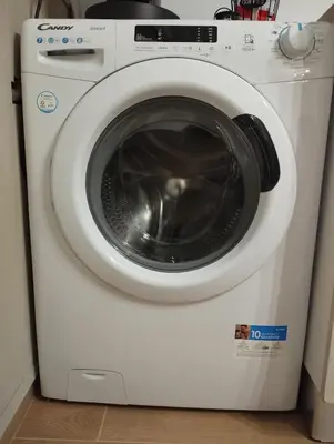 a white washing machine is sitting in a kitchen at Casa Palù Sicilia in Altavilla Milicia