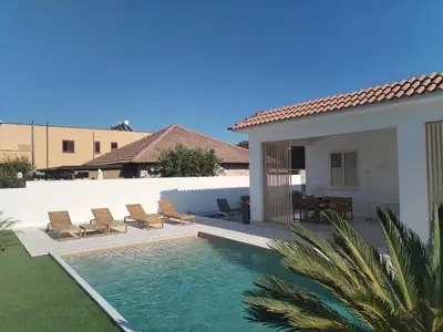 a swimming pool in front of a house at Villa Marina di Calatubo in Alcamo