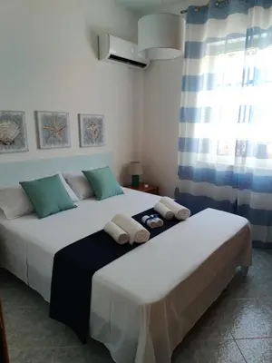 two beds sitting next to each other in a bedroom at Villa Marina di Calatubo in Alcamo