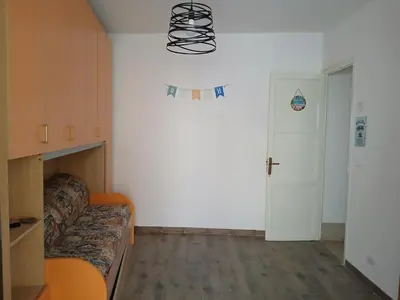 a small room with a bed and a white wall at Sonalerba Ammare Trabia H H in Trabia