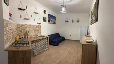 a kitchen with a sink and a stove in a room at Sonalerba Ammare Trabia H H in Trabia