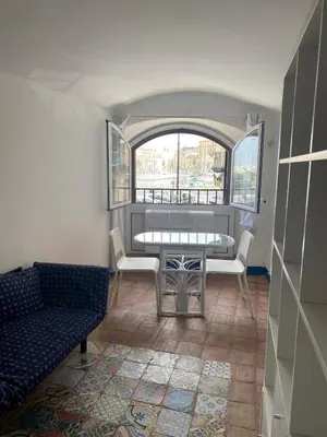 a room with a table and chairs and a window at B&B Al Porto Home in Palermo